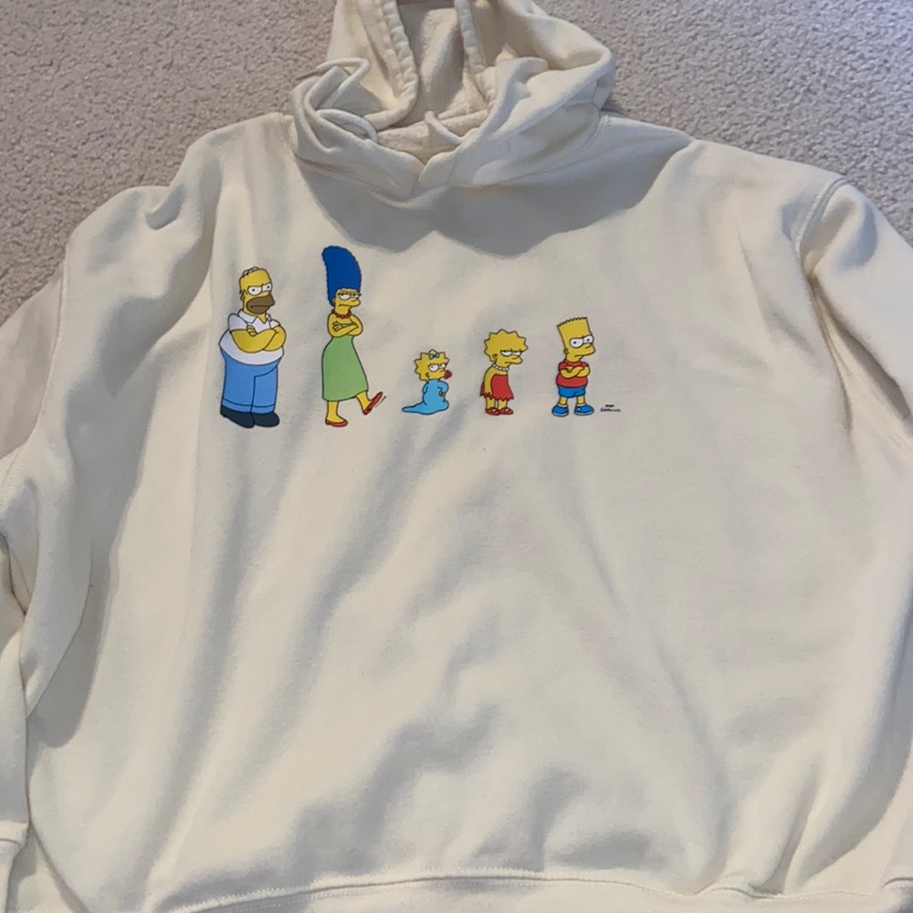 Juniors size M, ivory colored hoodie featuring the Simpson’s